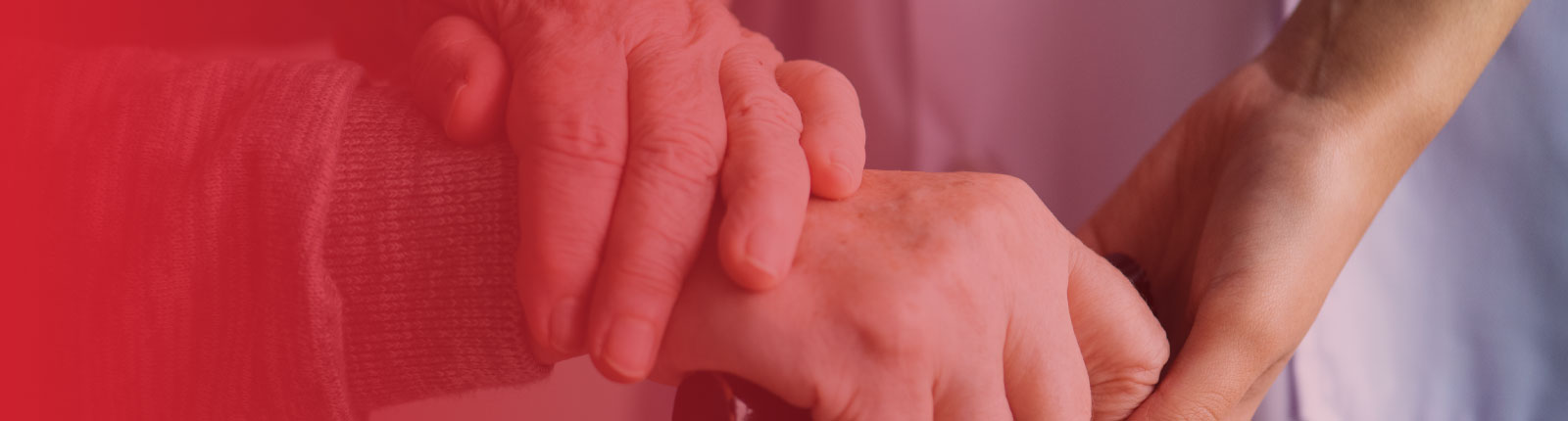 assisted living employee holding residents hands