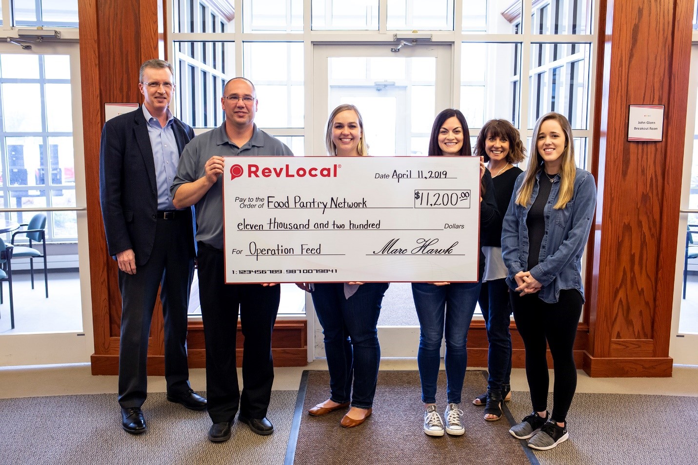 RevLocal employees award check to The Food Pantry Network of Licking County